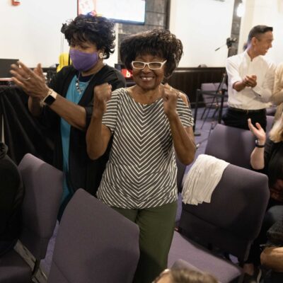 Audience members smile and applaud after a Landmarks Orchestra performance.